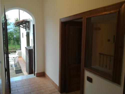 a hallway with a glass door and a mirror at Agriturismo Costiera Amalfitana in Tramonti