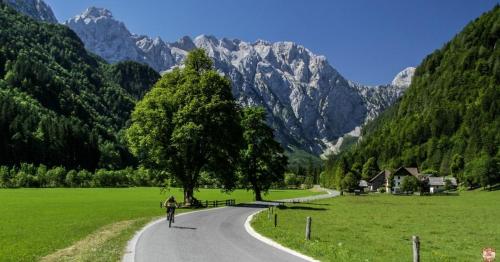 a person riding a bike down a road at Entire Loft close to Beautiful Logar Valley in Rečica ob Savinji