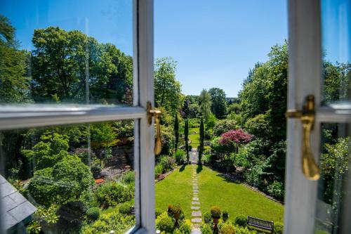 a view from a window of a garden at The Cors Country House in Laugharne