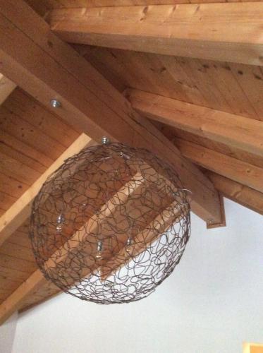 a metal basket hanging from a wooden ceiling at Steuer 59 App 5 in Annaberg im Lammertal