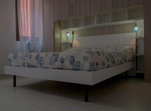 a large bed in a bedroom with a bed frame at casa dei nonni in Murano