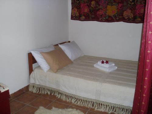 a small bed in a room with a window at Ostria's House in Kissamos