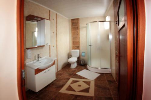 La salle de bains est pourvue d'un lavabo, de toilettes et d'une douche. dans l'établissement Boomerang Guest House, à Selçuk