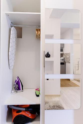 a room with white walls and a white closet at Carla's apartment -shuttle in Iaşi