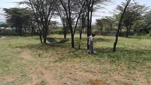 a man playing with a soccer ball in a field at Oldarpoi Wageni Camps in Keekorok