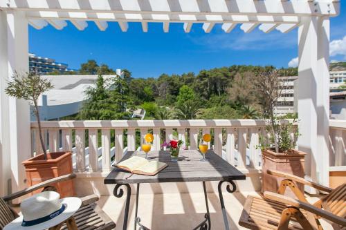 a table on a balcony with glasses of orange juice at Apartments Grifone Lux in Herceg-Novi