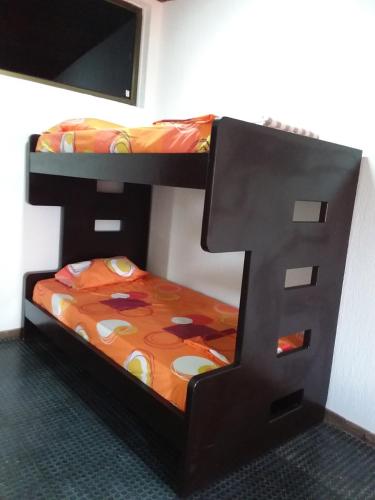 two bunk beds in a room with a bed at Parcelación El Lago in Cali