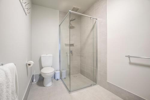a bathroom with a glass shower with a toilet at Nightcap at Chardons Corner Hotel in Brisbane