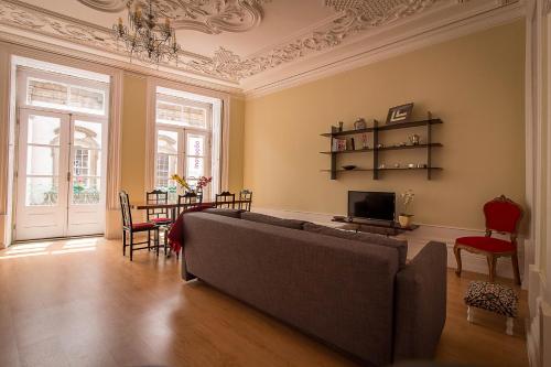 a living room with a couch and a table at São Domingos Flowers Apartments in Porto