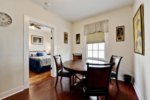 a dining room with a table and chairs and a bed at New Orleans Cottage in New Orleans