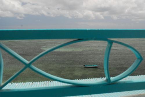 a boat in the water on a bridge at Le Recif Hotel Rodrigues in Rodrigues Island