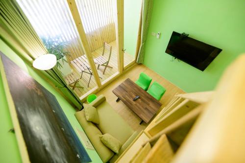 a small living room with a couch and a television at 夏海民宿 in Magong