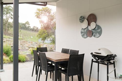 a dining room with a wooden table and chairs at Esto house in Crafers