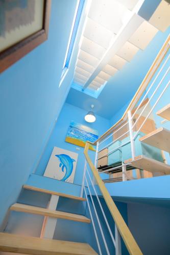 a staircase in a room with blue ceilings at 夏海民宿 in Magong