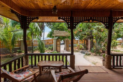 a pavilion with chairs and a table and a table at Anse Severe Beach Villas in La Digue