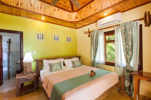 a bedroom with a large bed in a room at Anse Severe Beach Villas in La Digue
