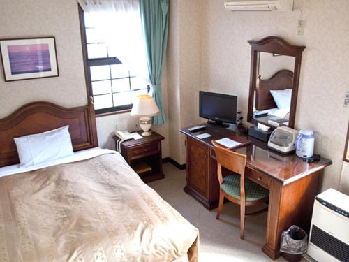 Postel nebo postele na pokoji v ubytování Aiwa no Mori Hotel