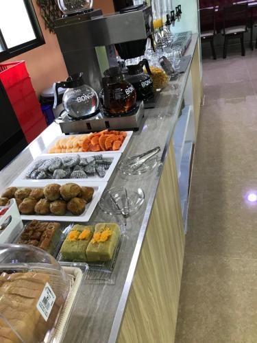 a buffet line with many different types of pastries at Wish Hotel Ubon in Ubon Ratchathani