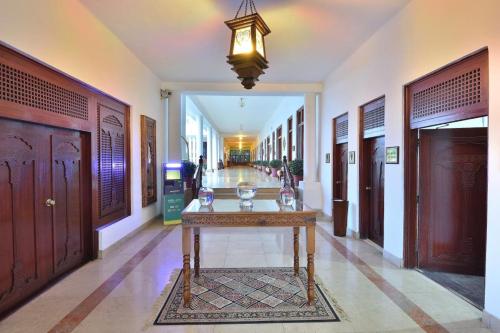 a hallway with a table in the middle of a building at Swat Serena Hotel in Saidu