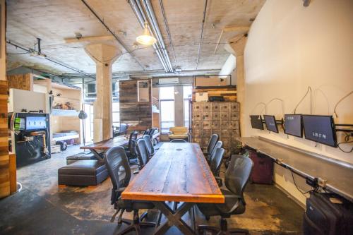 a conference room with a wooden table and chairs at PodShare Hollywood in Los Angeles