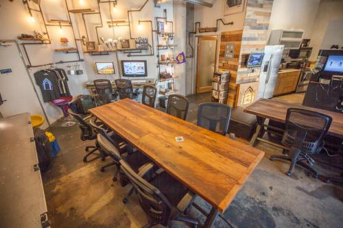 a room with a large wooden table and chairs at PodShare Hollywood in Los Angeles