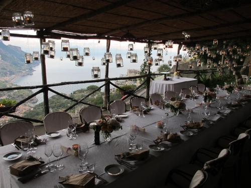 a table set up for a wedding with a view at Hotel Parsifal - Antico Convento del 1288 in Ravello