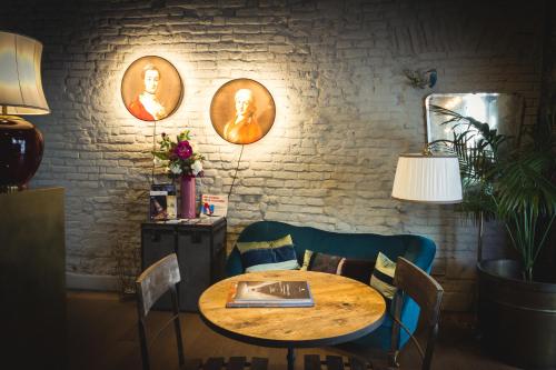 a dining room with a wooden table and chairs at Piccola Torre Maison in Vigevano