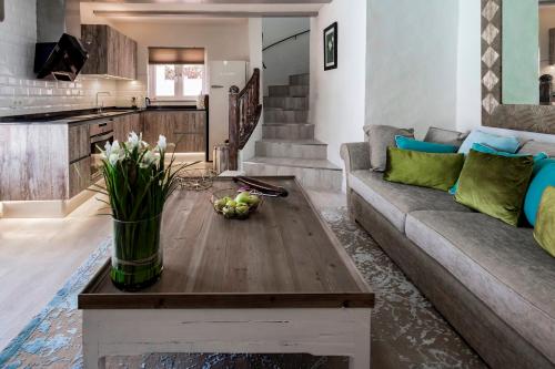 a living room with a couch and a table at Deluxe designer historic villa Via Lactea, Panoramic sea views, Own private heated pool and subtropical garden in La Asomada