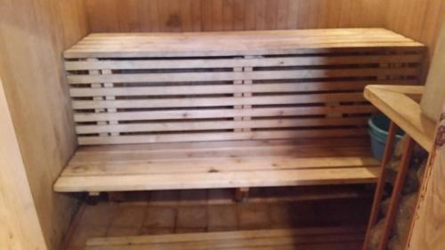 a wooden bench sitting in a small room at Vasarnamis Zarasuose in Zarasai