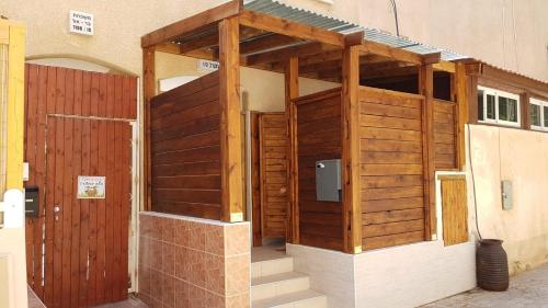 an outside view of a building with a wooden door at The Taras unit in Eilat