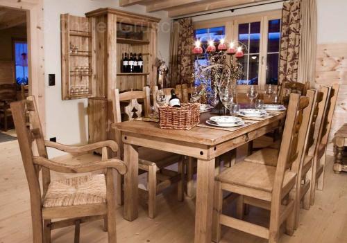 a wooden table with chairs and a dining room at Chalet Grüsch in Grüsch