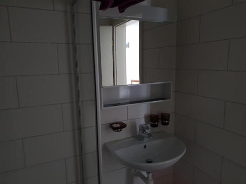 a bathroom with a sink and a mirror at Swiss Chalet Holidays Ringgenberg in Ringgenberg