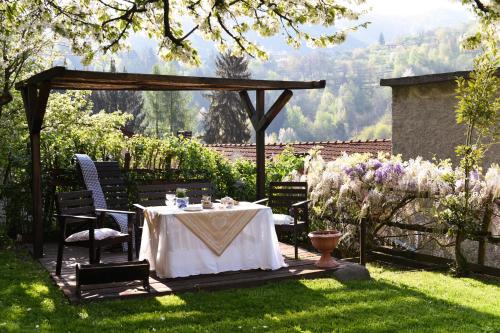 uma mesa num jardim com um gazebo em B&B Va...lentina em Piavata