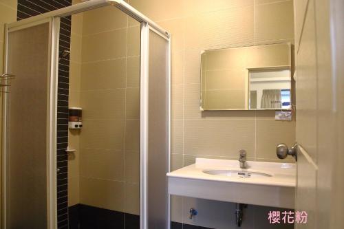 a bathroom with a sink and a mirror at 羅東夜宿 in Luodong