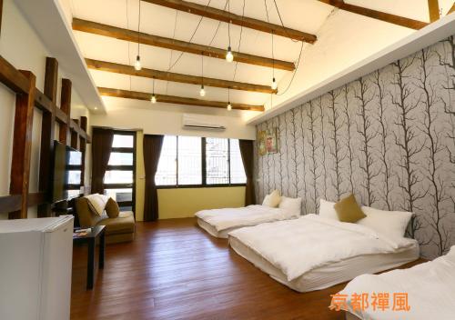 a living room with two beds and a couch at 羅東夜宿 in Luodong