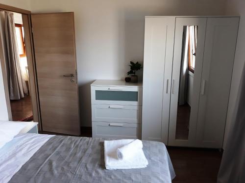 a bedroom with a bed and a dresser and a mirror at BELLAVISTA Luxury Lodge in Korčula
