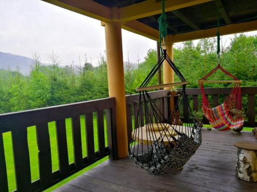 a porch with hammocks hanging from a gazebo at Dwór Roh in Wetlina