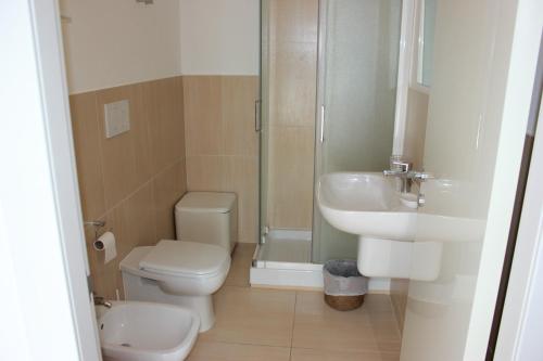 a bathroom with a toilet and a sink and a shower at Ai Giardini di San Vitale in Ravenna
