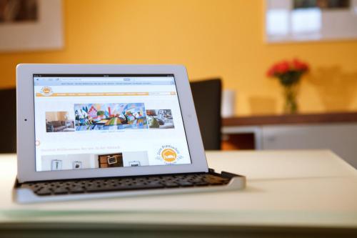 a laptop computer sitting on top of a table at Landhotel Zum Pottkuchen in Kalbe