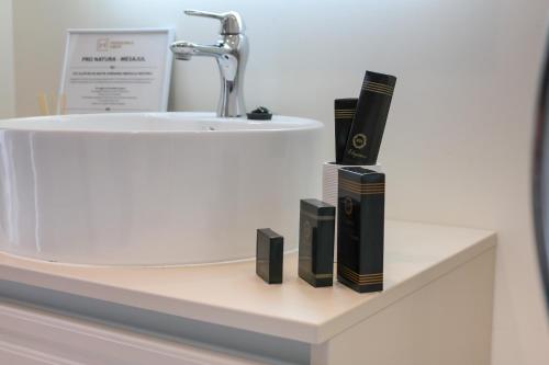 a bathroom counter with a sink and books on it at Pensiunea David in Târgu-Mureş