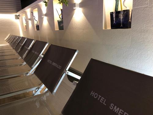 a row of chairs in a room with a hotel synergy sign at Hotel Smeraldo in Qualiano