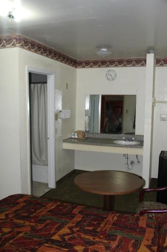 a hotel room with a table and a mirror at Choice Inn San Antonio in San Antonio