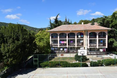 a building with a basketball court and a basketball hoop at Ahilea Hotel - Free Pool Access in Balchik