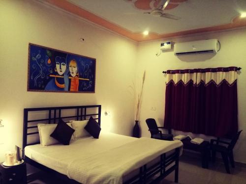 a bedroom with a bed and a painting on the wall at Ranthambhore Tiger Valley in Sawāi Mādhopur