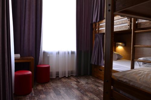 a bedroom with two bunk beds and a window at Music Hostel in Poltava