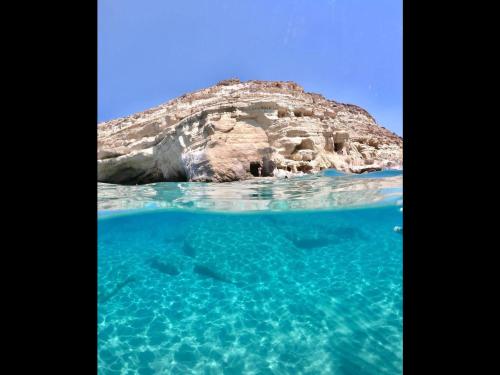 an island in the ocean with blue water at Ageliki Studio in Matala