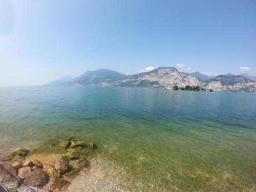 a large body of water with mountains in the background at Hotel Villa Isabella in Brenzone sul Garda