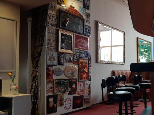 a wall with pictures and posters in a barber shop at Rembrandtplein Hotel in Amsterdam