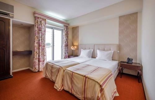 Katil atau katil-katil dalam bilik di Catolica Hotel