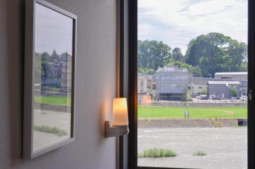 a window with a view of a field at sararaso in Kanazawa